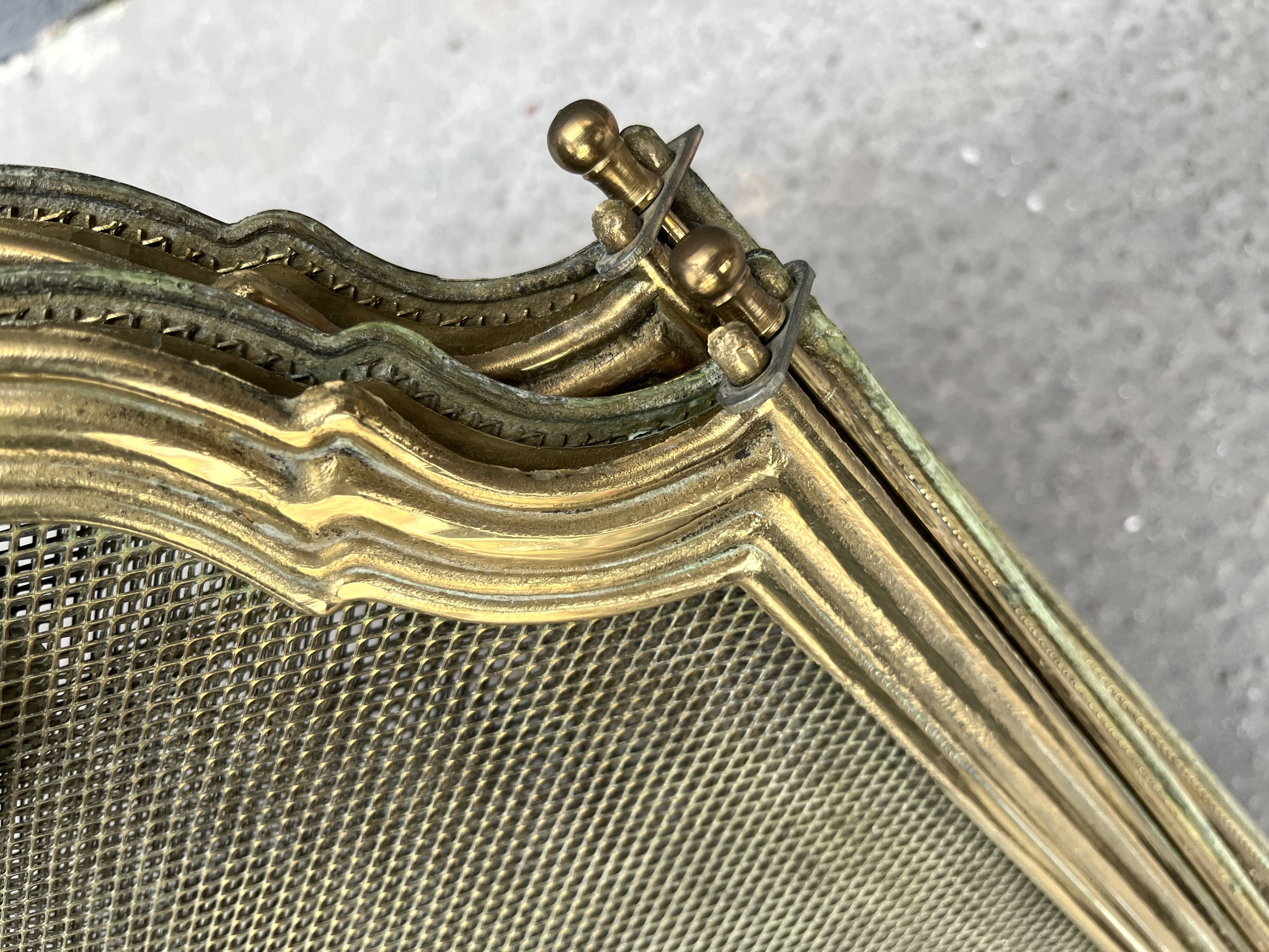 Antique brass fireplace screen from 1920, vintage spark guard.
