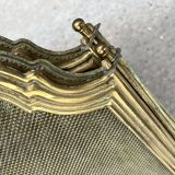 Antique brass fireplace screen from 1920, vintage spark guard.
