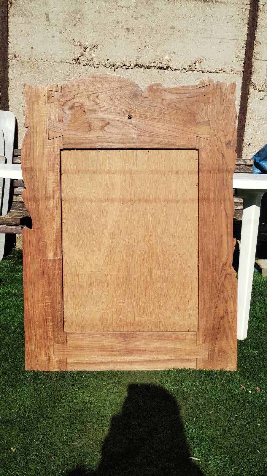 Pretty beveled mirror with wooden frame and floral decoration.