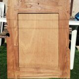 Pretty beveled mirror with wooden frame and floral decoration.