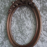 Wooden oval frame with carved pediment