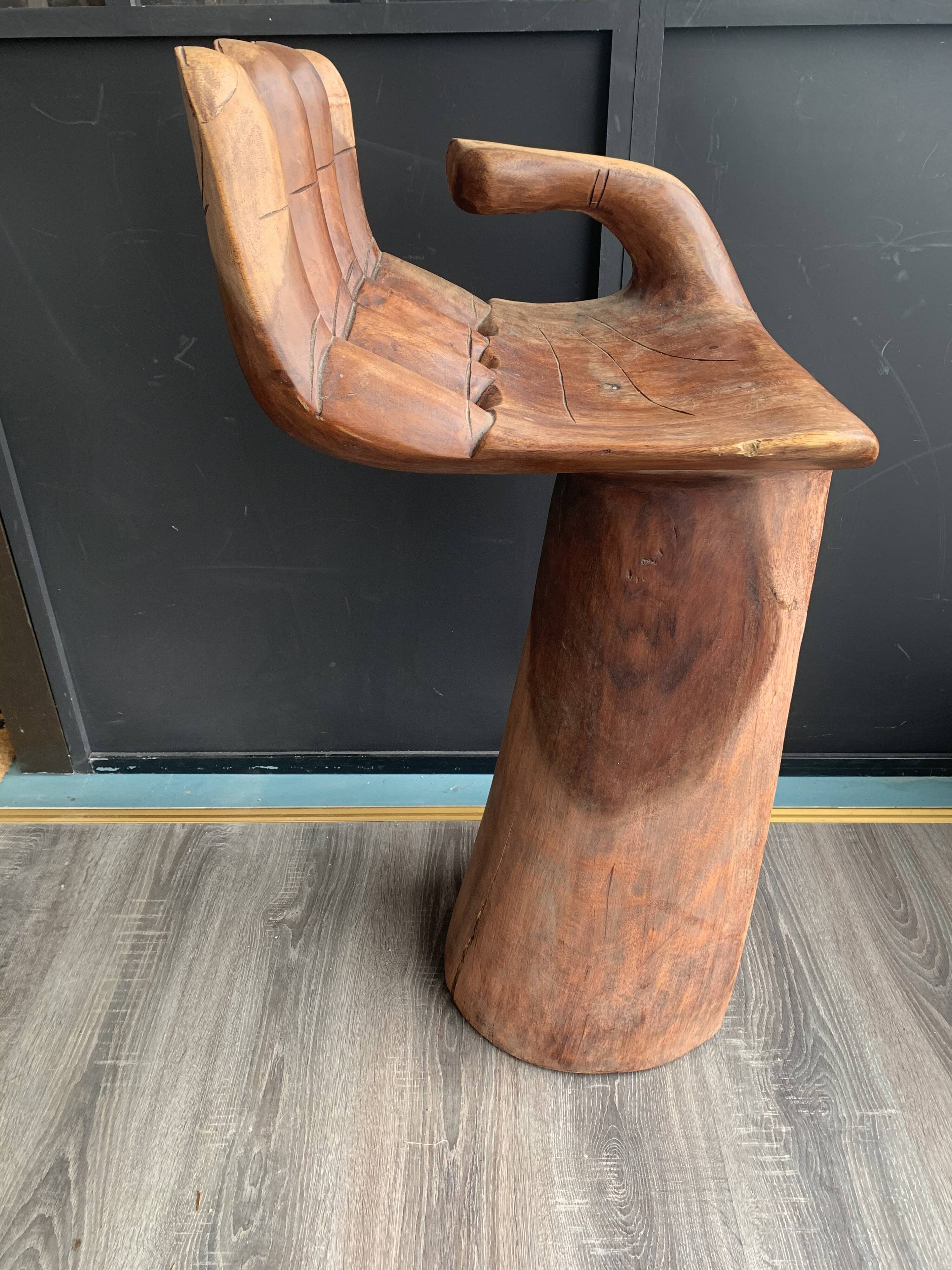 Hand-shaped carved wooden stool