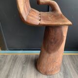Hand-shaped carved wooden stool