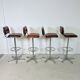 1970s chrome bar stools with cognac-colored faux leather upholstery