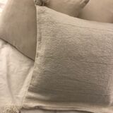 White cushion cover with pom poms