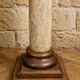 Wood and lacquer pedestal column table mimicking marble, 19th century.