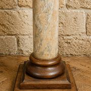 Wood and lacquer pedestal column table mimicking marble, 19th century.