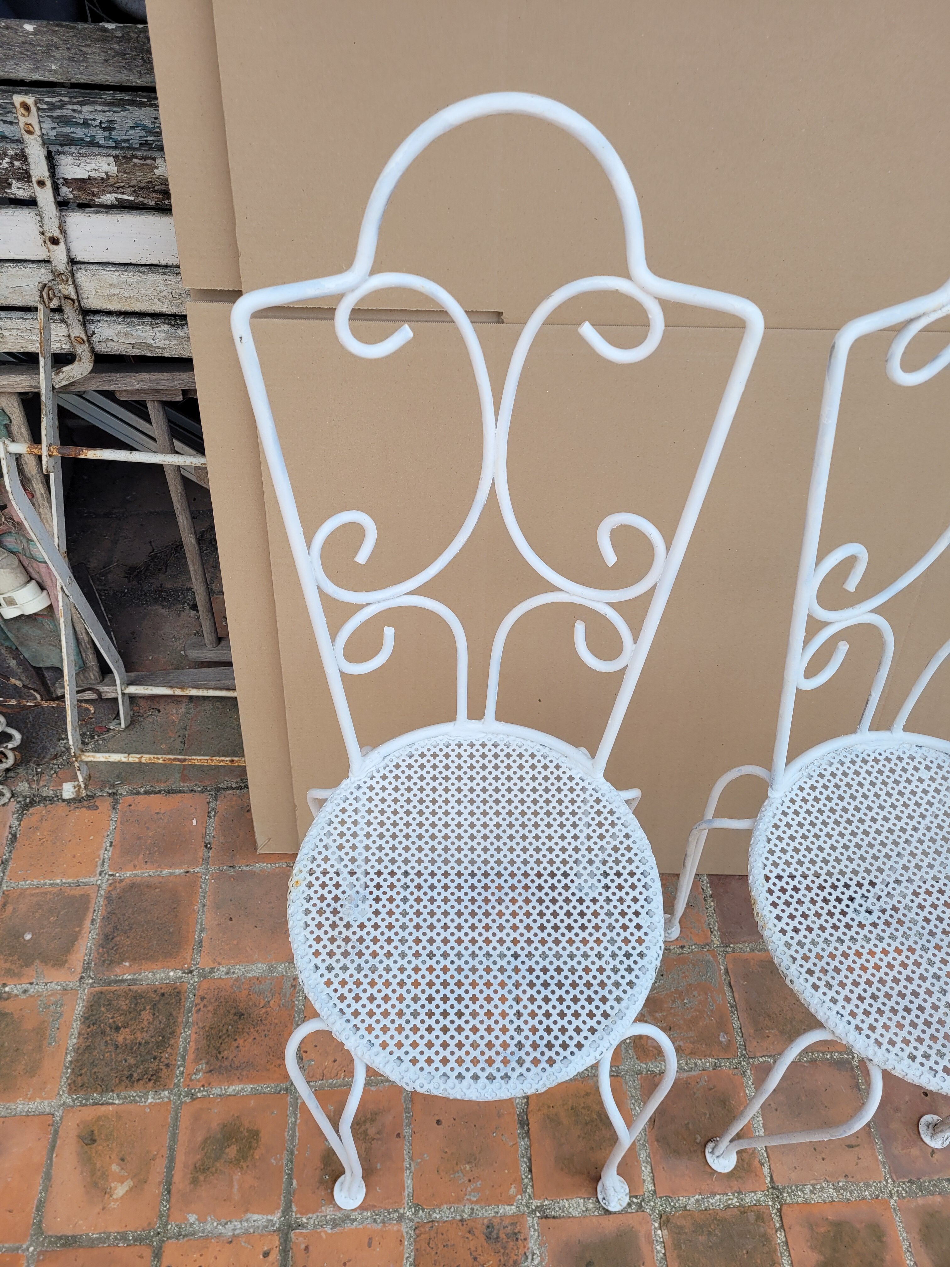 Pair of antique wrought iron garden chairs