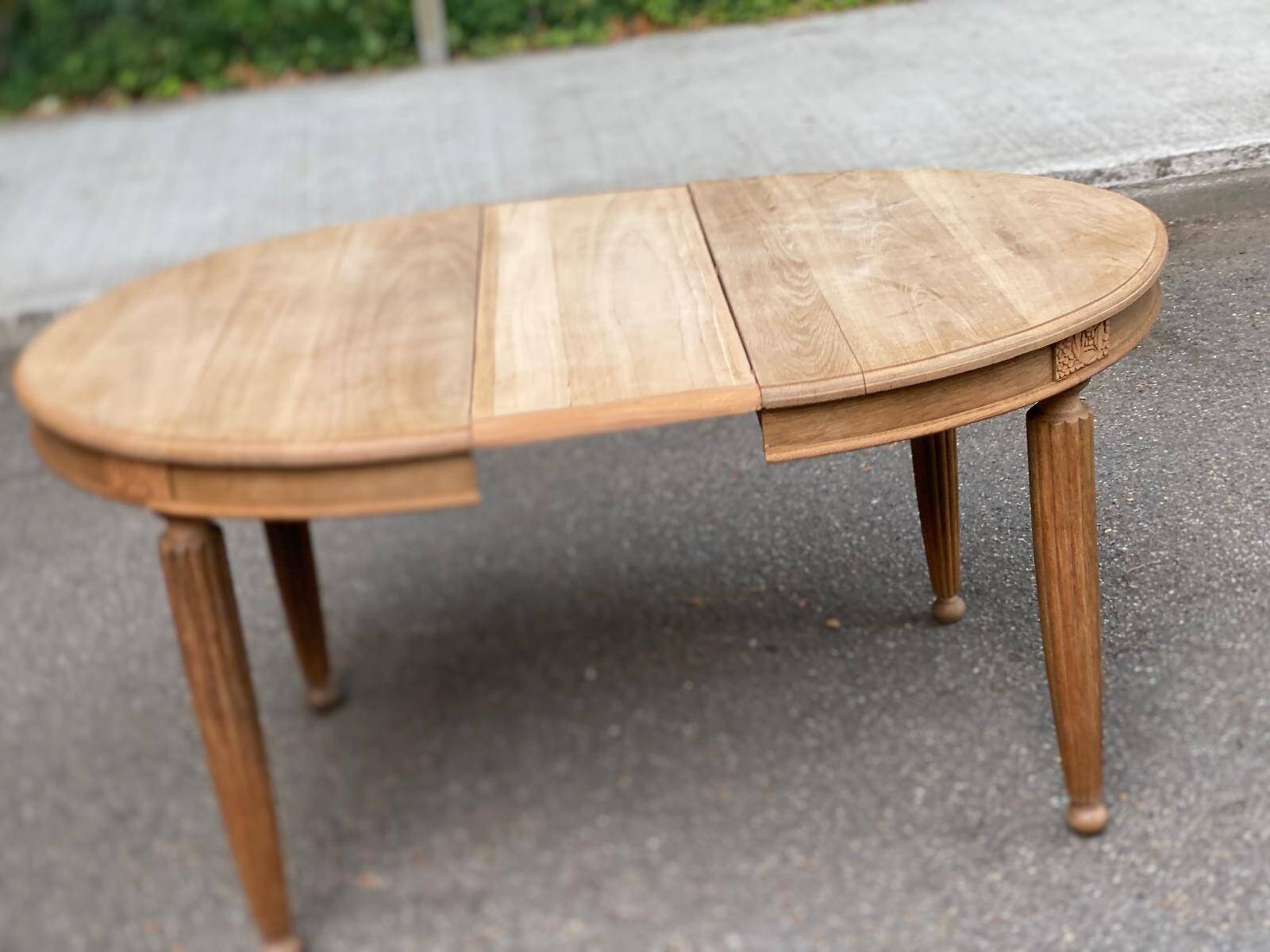 Large stripped solid oak dining table in Louis XVI style with 3 extensions.