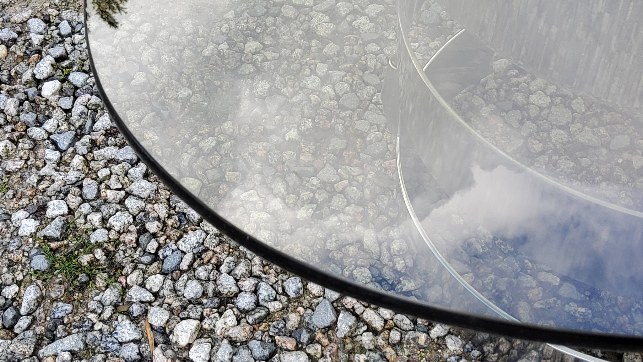 Oval coffee table of the 70s chromed metal base in s smoked glass top