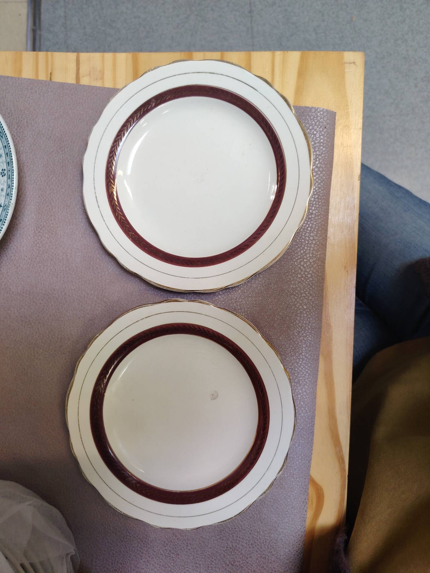 Salins white ceramic dessert plates with red trim and gold rim.
