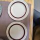 Salins white ceramic dessert plates with red trim and gold rim.