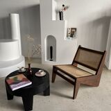 Reclined armchair in canned teak in natural wood