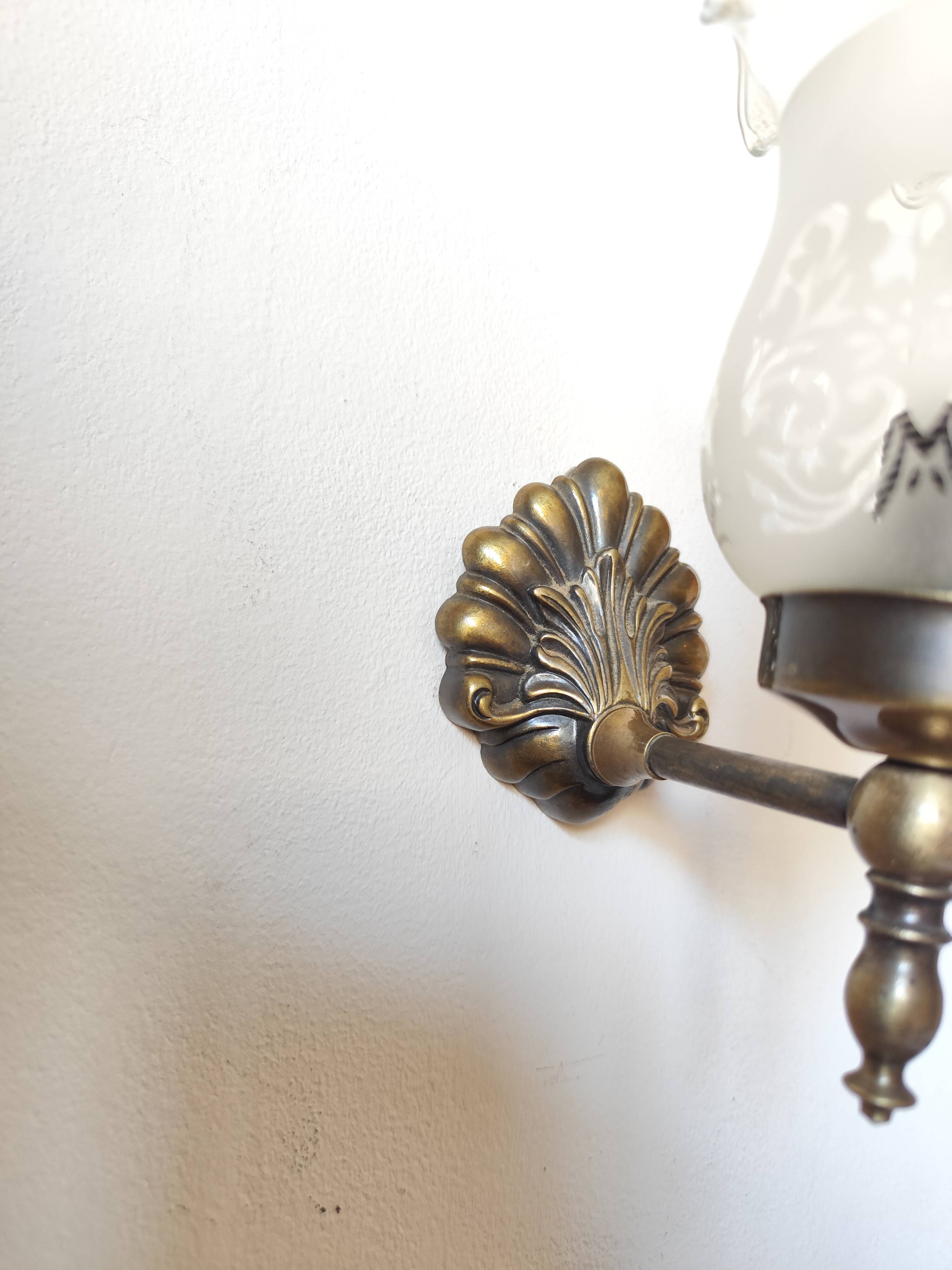 Pair of wall sconces in bronze with opaline glass tulips.