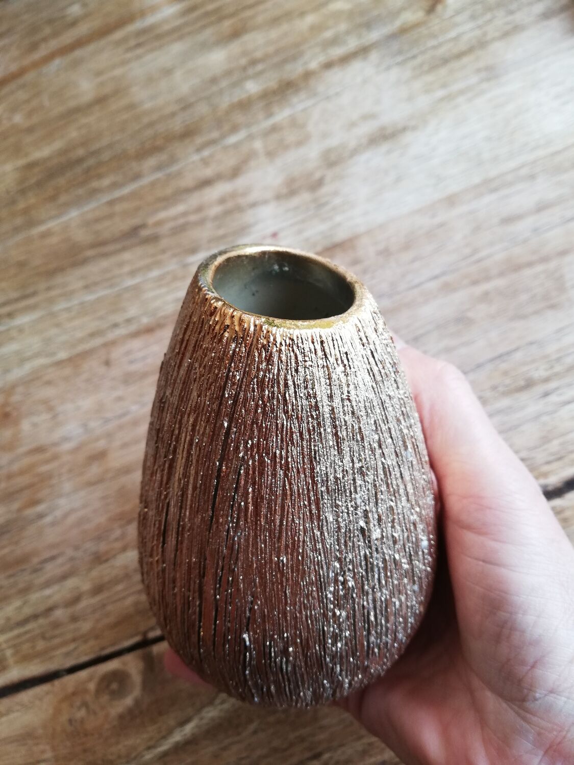 Small asymmetrical golden seed-shaped vase
