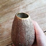Small asymmetrical golden seed-shaped vase