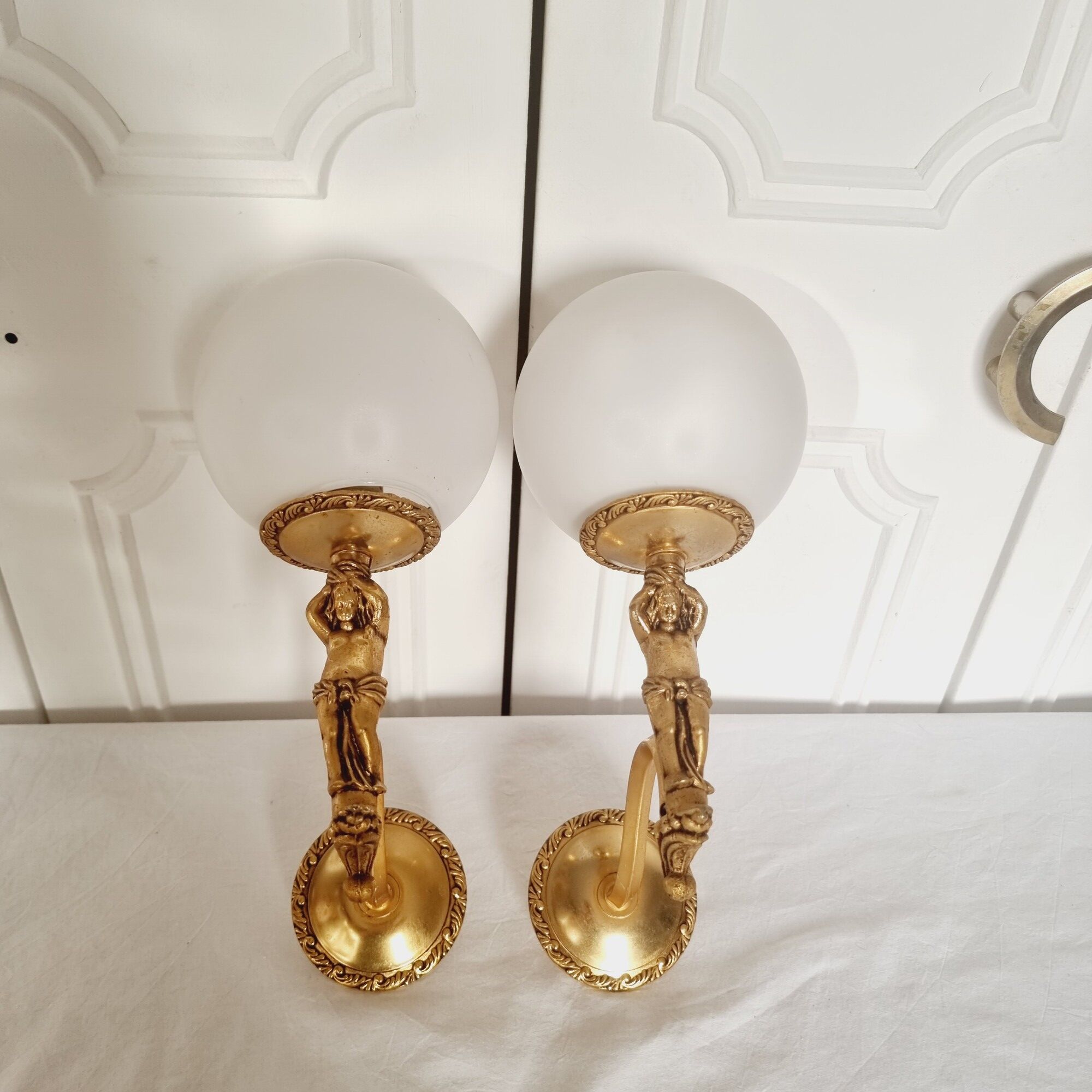 2 classic golden cherub wall lights and globe lampshades in perfect condition.