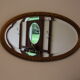 Beveled oval mirror in gilded wood