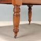 Antique extendable mahogany table with a crank mechanism, United Kingdom.