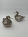 A pair of silver-plated ice buckets featuring a duck by Mauro Manetti.