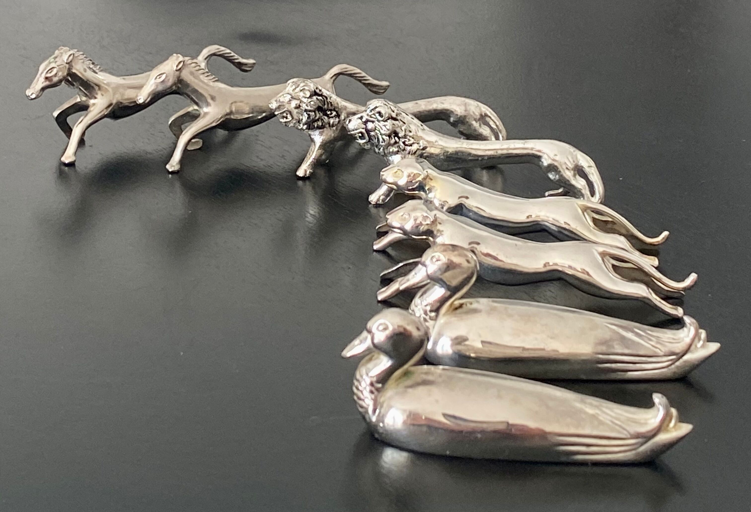 8 various animal knife holders in silver metal