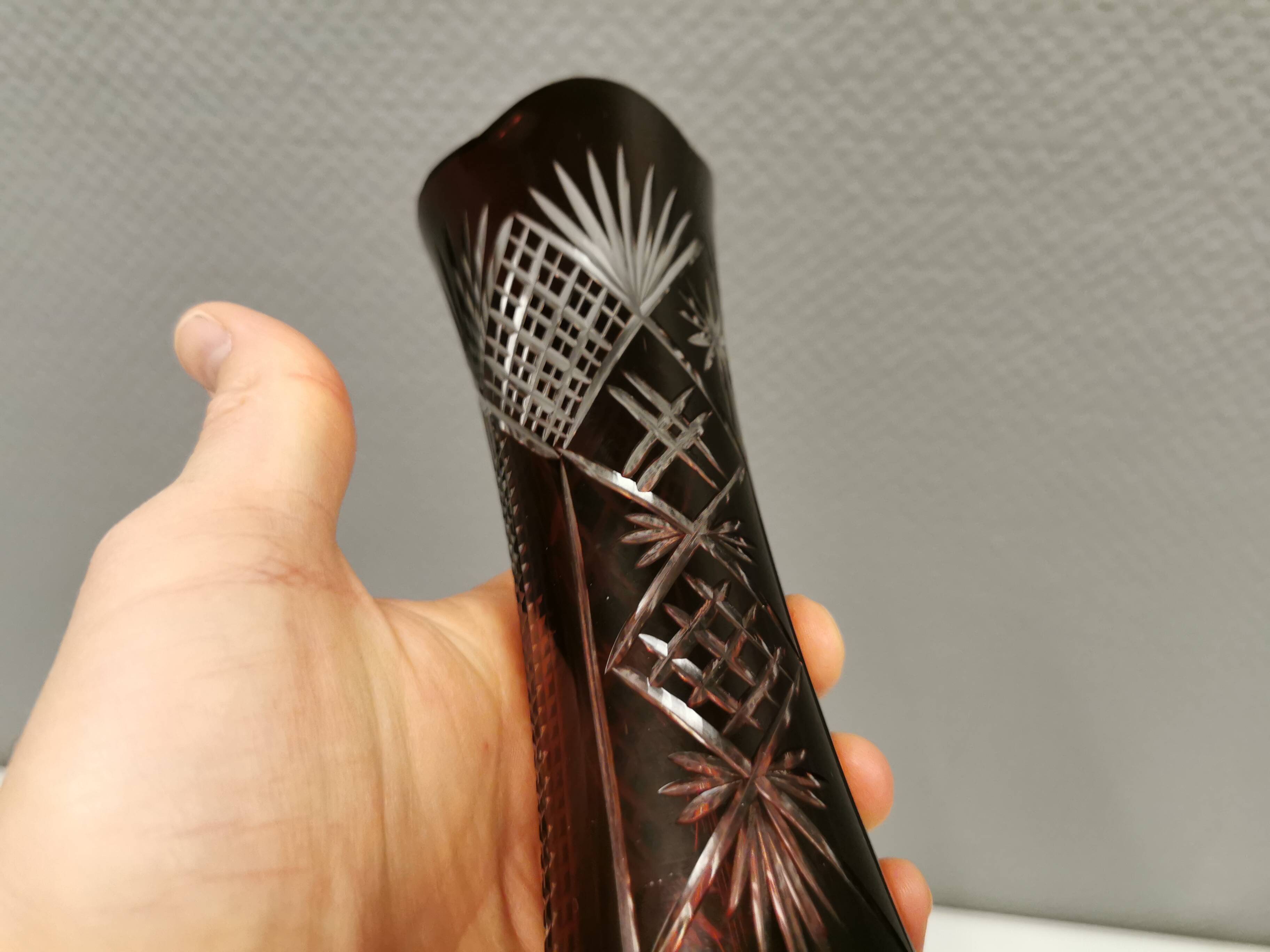 Crystal glass vase, in burgundy/reddish coloured glass with translucent details.