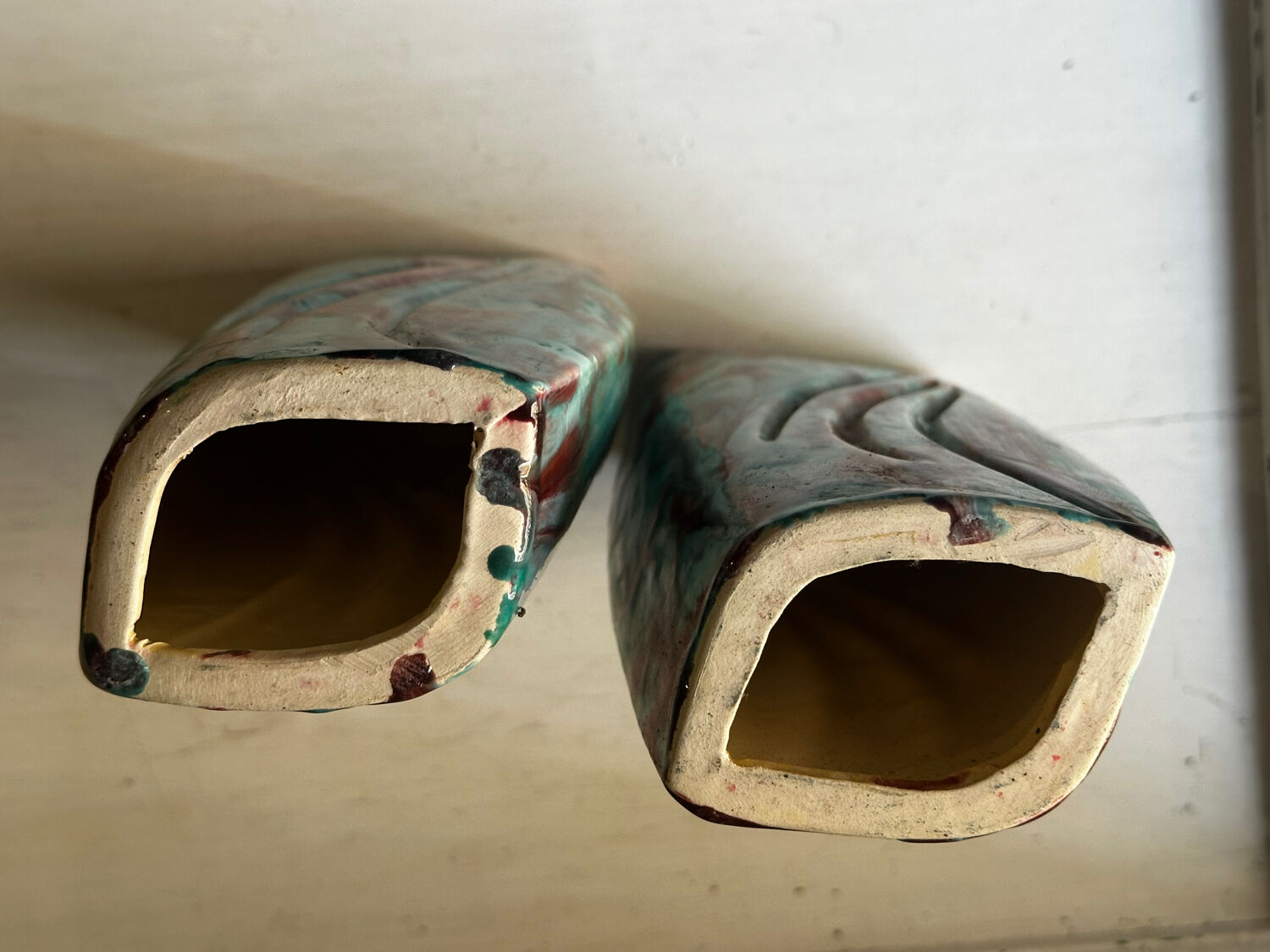 Vintage pair of turquoise and red ceramic candlesticks