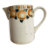 Old ceramic pitcher with orange decoration.