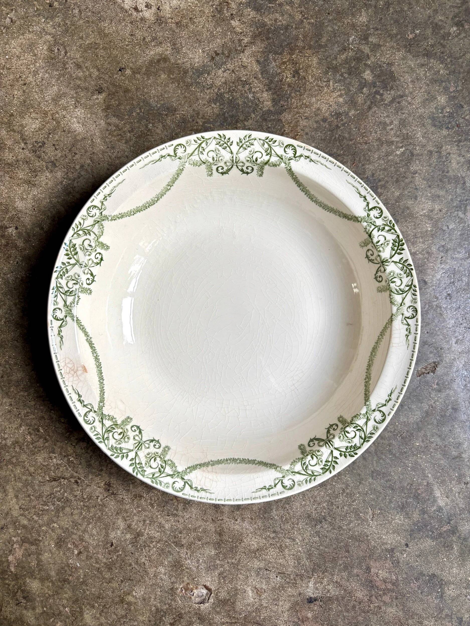 Round, deep Creil & Montereau dish in green earthenware, "Napoleon" service