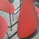 Lot of 6 red chairs in faux leather metal compass feet