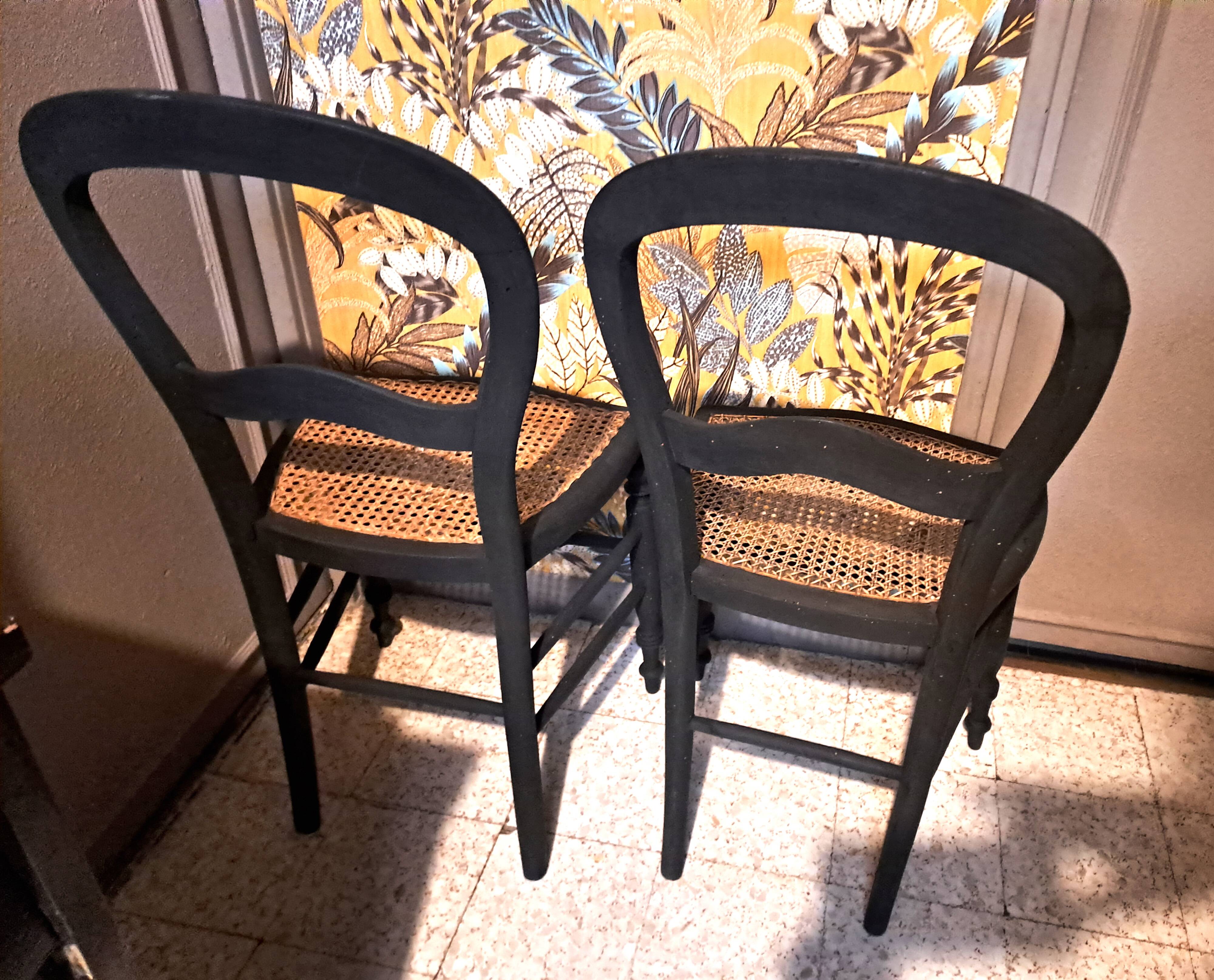 Pair of 2 chairs with cane seats in black wood, circa 1940