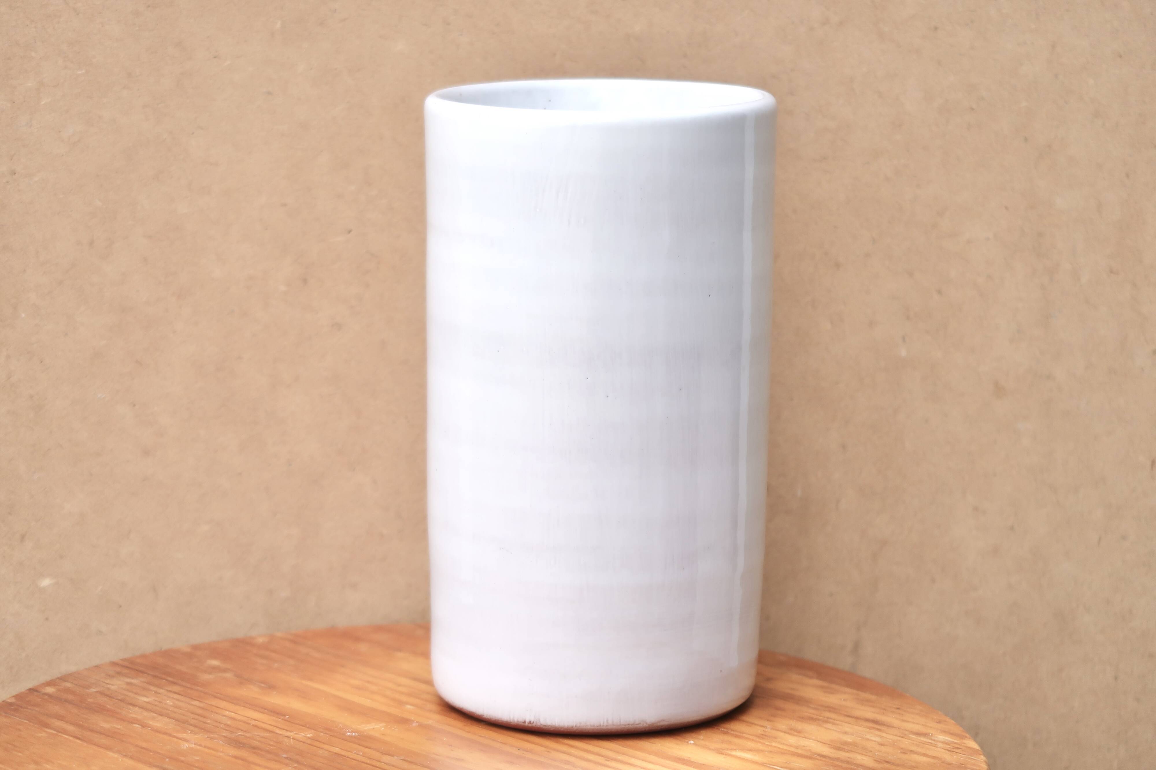 Vase by Antonio Lampecco minimalist white ceramic scroll