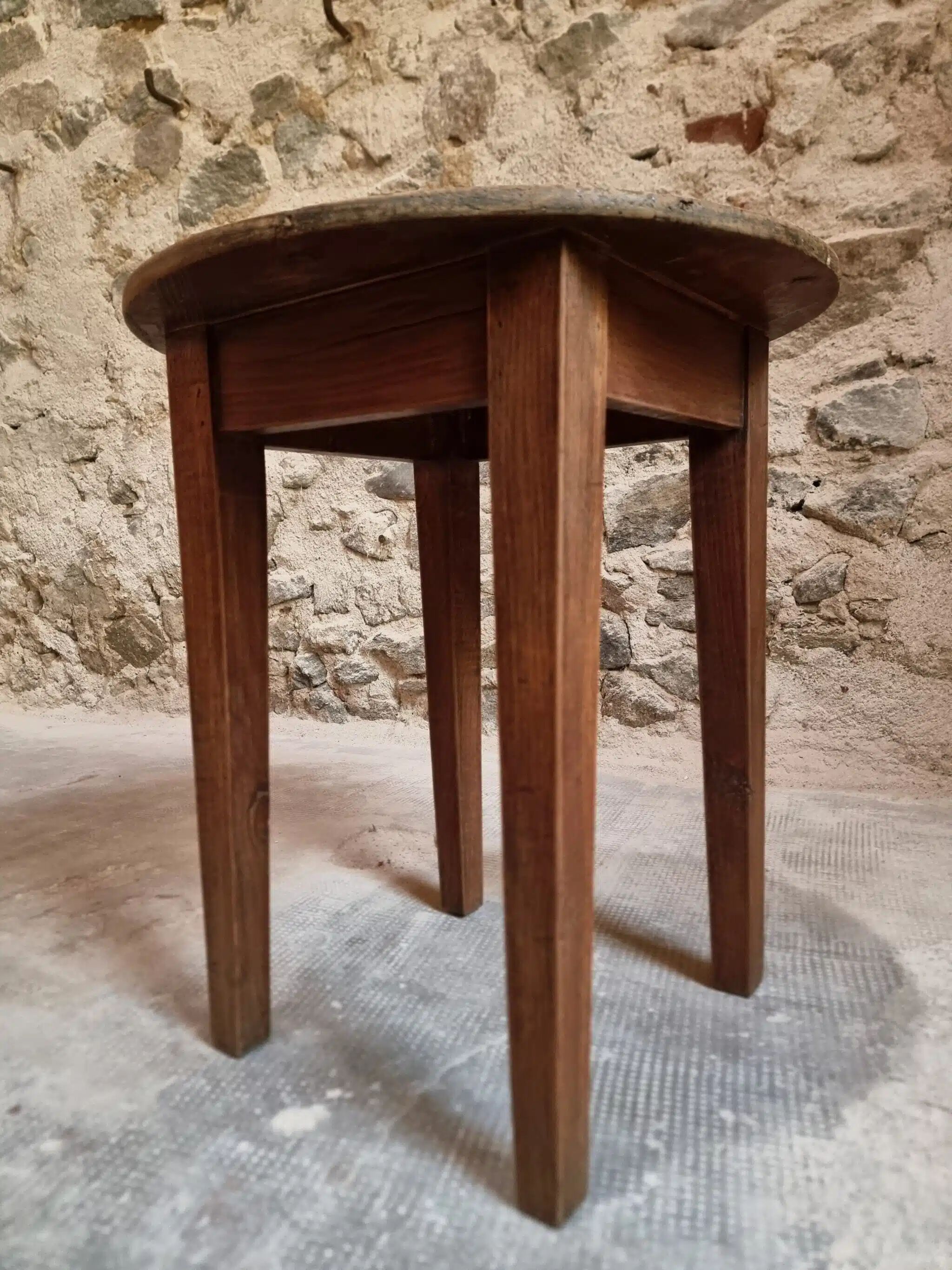 Antique round side table with oak legs and a pine top, circa 1900.