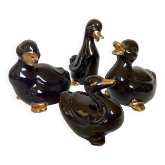 Four little black and golden ducks.