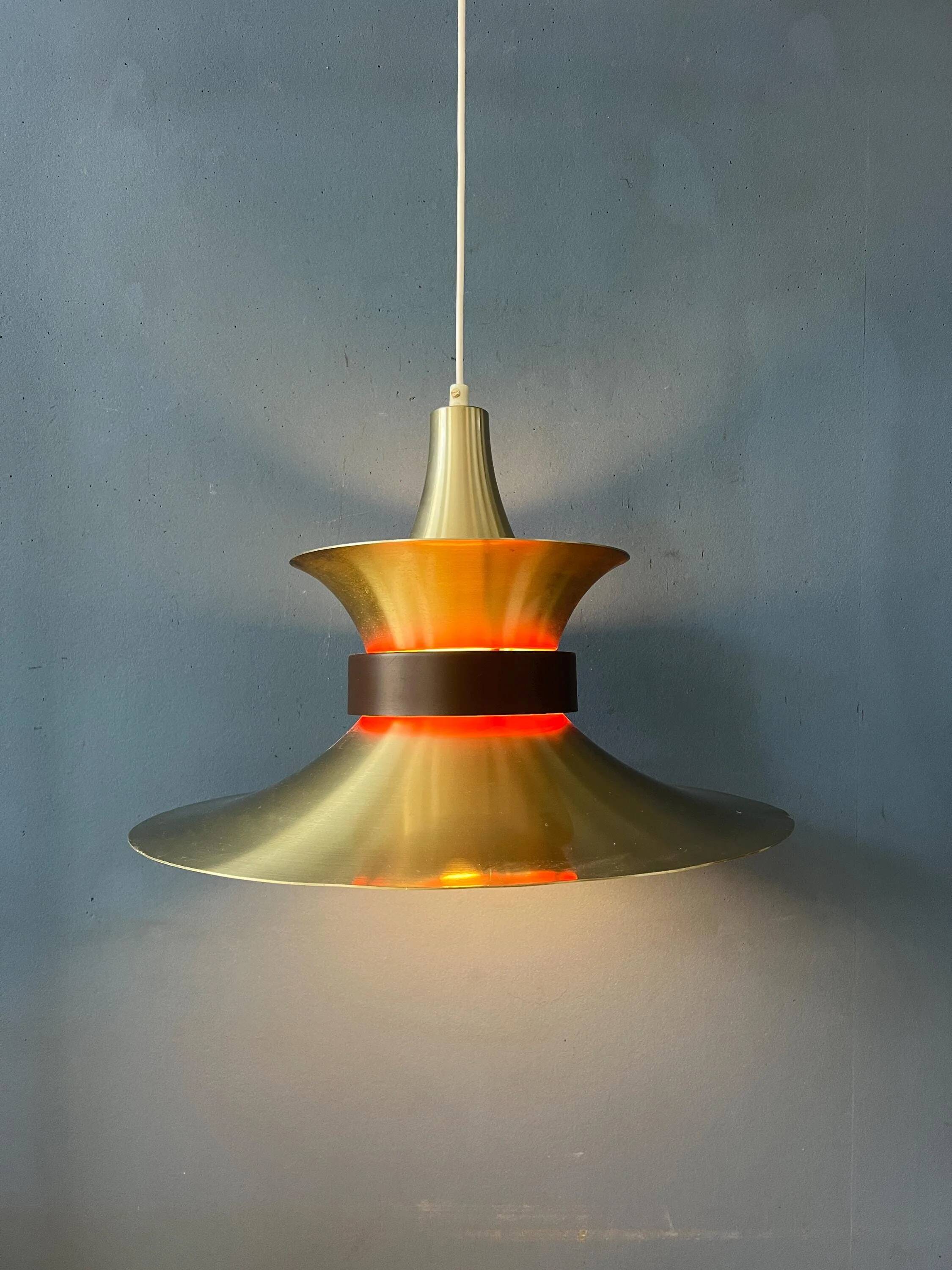 Large UFO flying saucer pendant light with orange light.