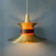 Large UFO flying saucer pendant light with orange light.
