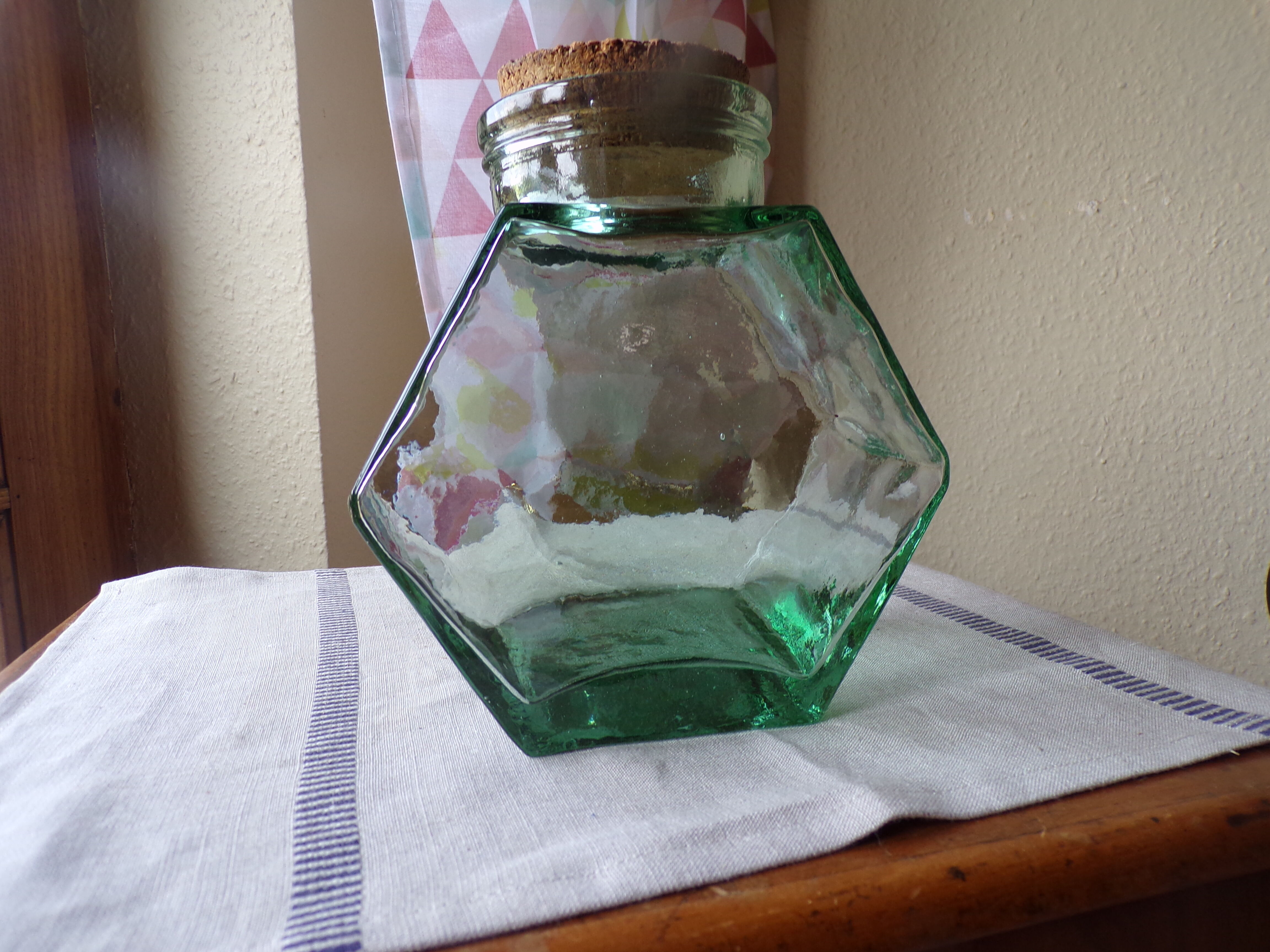 Old thick glass of a light green jar