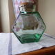 Old thick glass of a light green jar