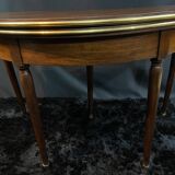 A Louis XVI period mahogany half-moon table forming a console/games table