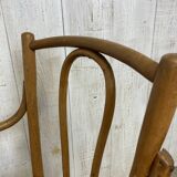 Curved wood and cane armchair