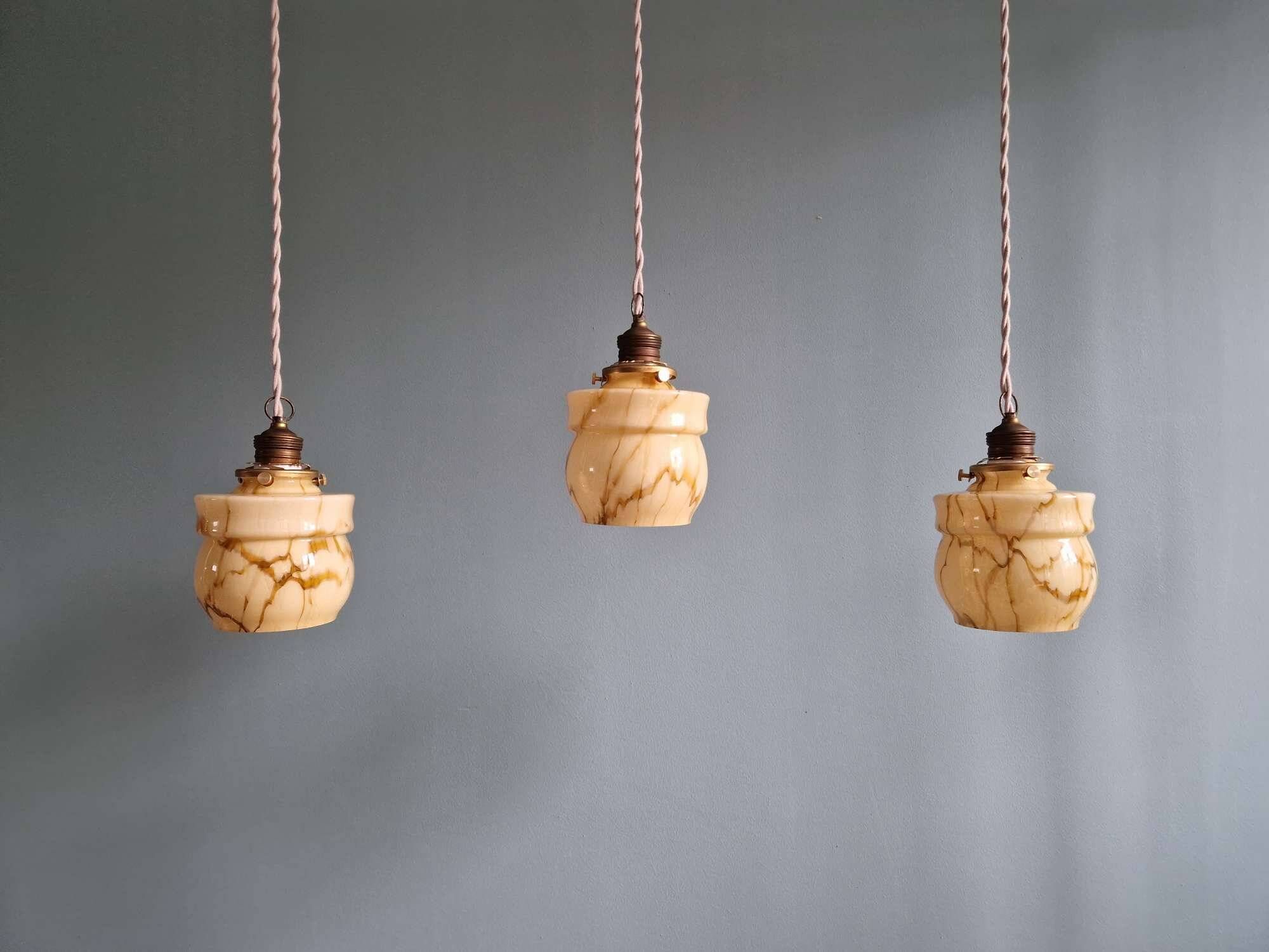 Art Deco trio of suspensions in opaline and marbled ouraline, Scailmont, 1920-30.
