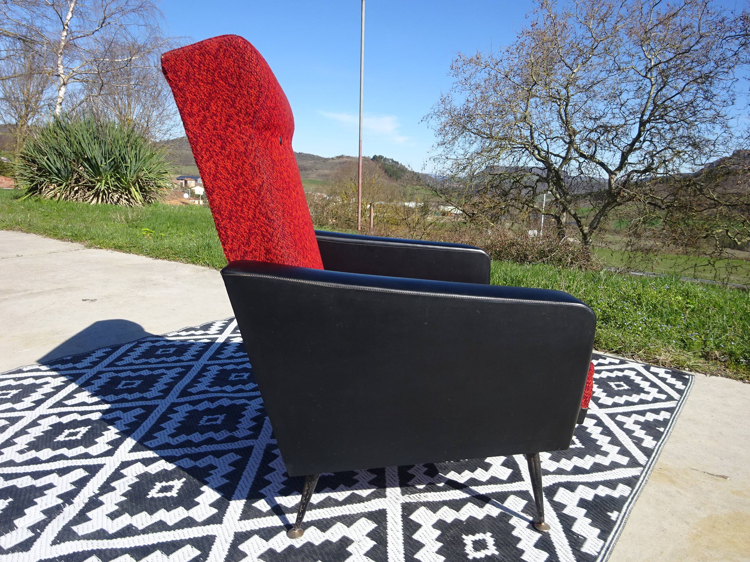 Vintage armchairs in red and black faux leather, the pair.