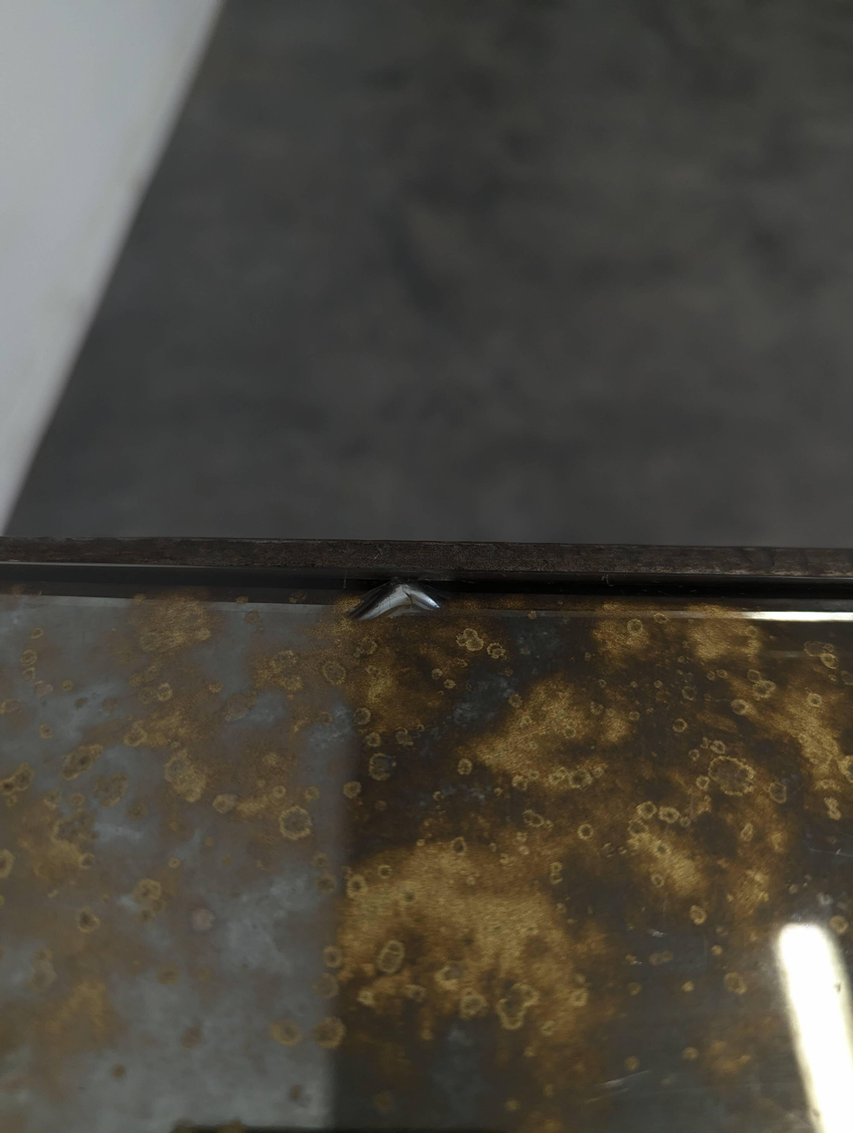 Neoclassical side table in wrought iron and eglomisé glass.