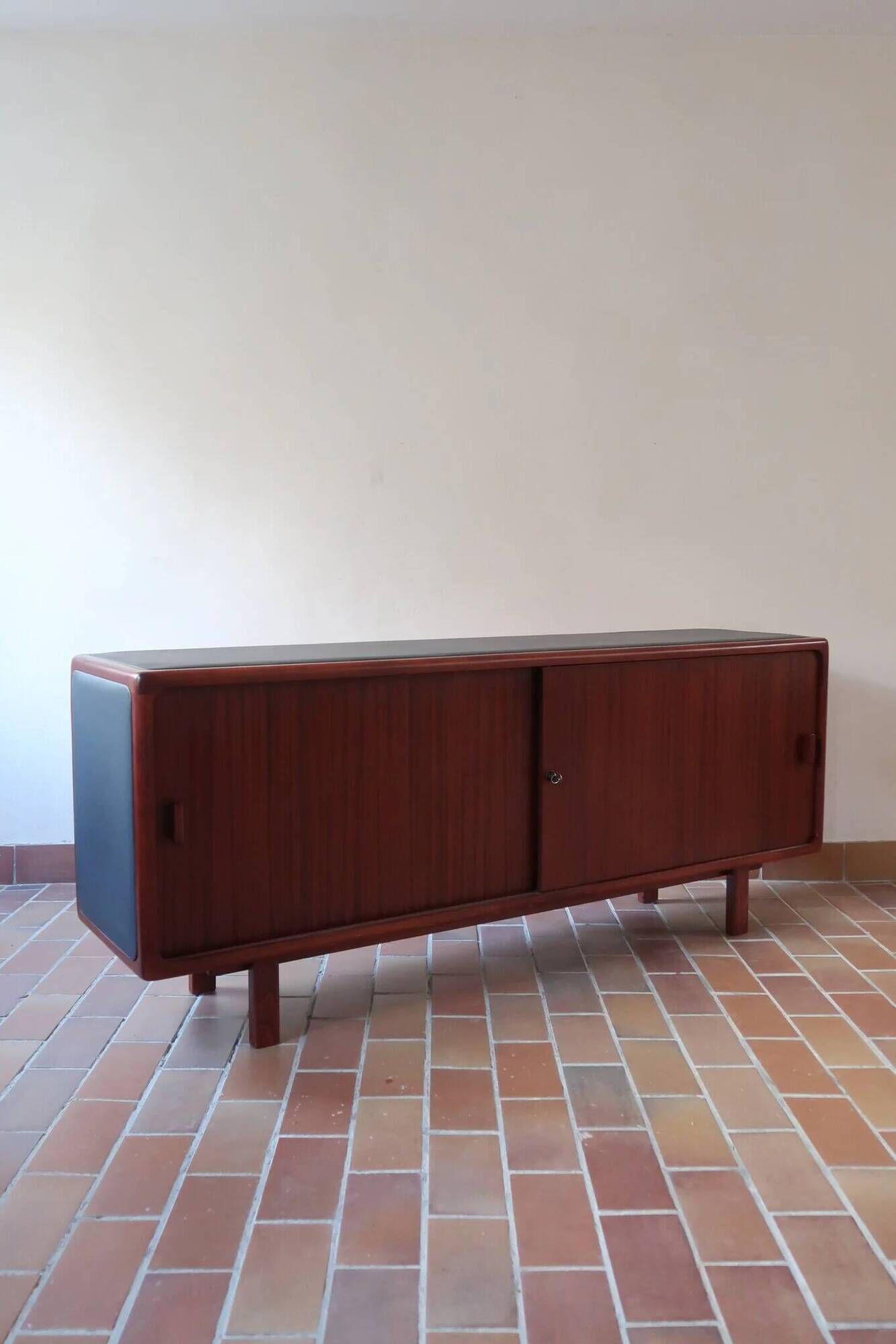 Teak enfilade, sliding doors, black faux leather top, 1970s.