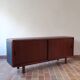 Teak enfilade, sliding doors, black faux leather top, 1970s.