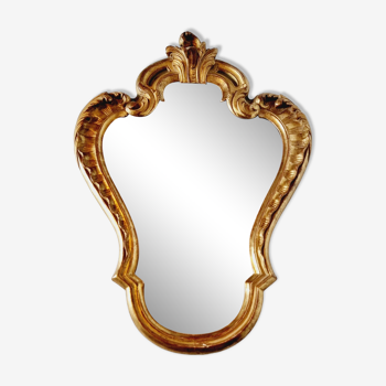 Antique mirror in gilded and green wood on top.