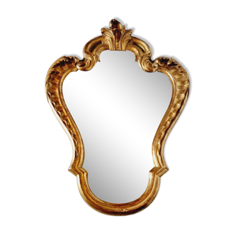Antique mirror in gilded and green wood on top.