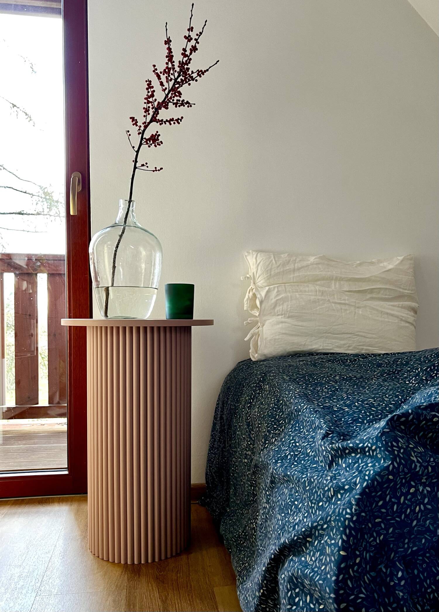 round and fluted bedside table in dusty pink