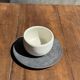 White Indonesian ceramic cup and gray saucer