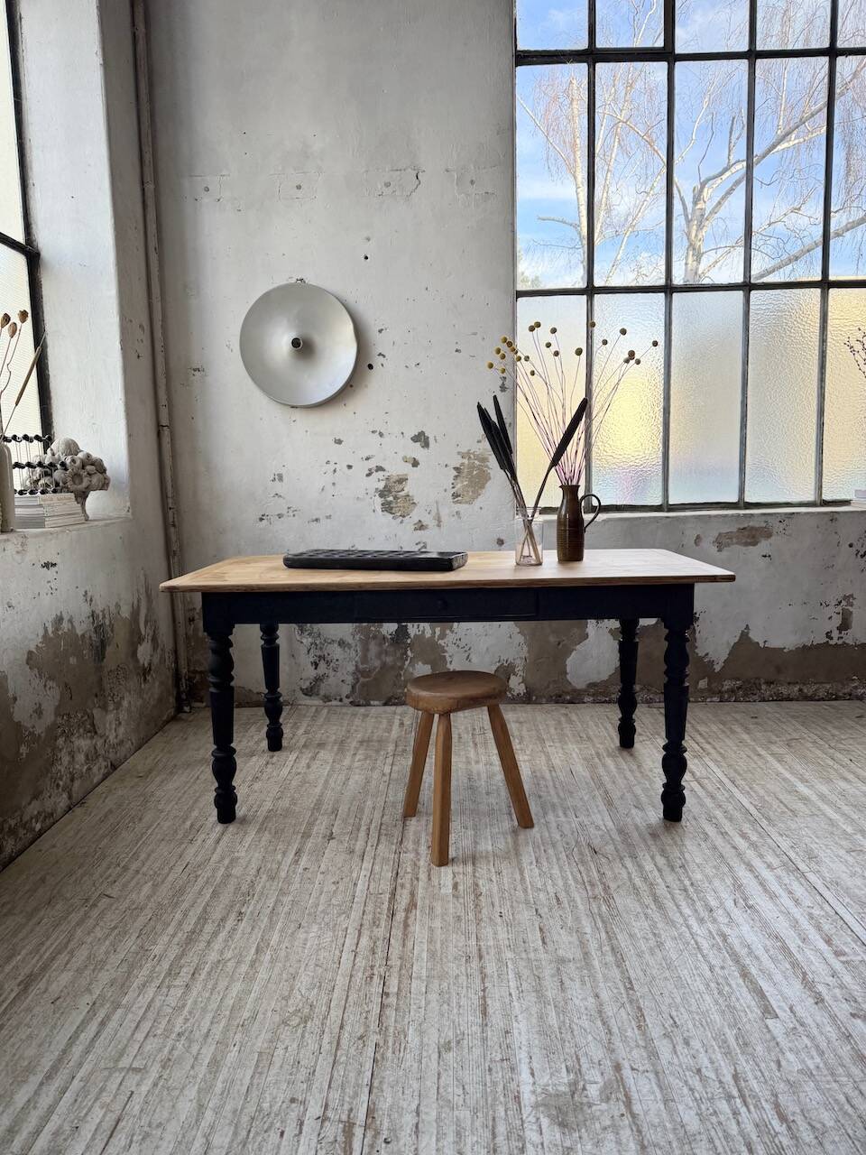 Oak farmhouse table with turned black legs.